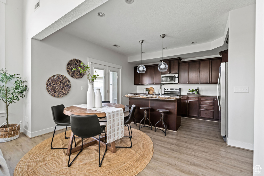 Dining room with light wood-style floors and baseboards