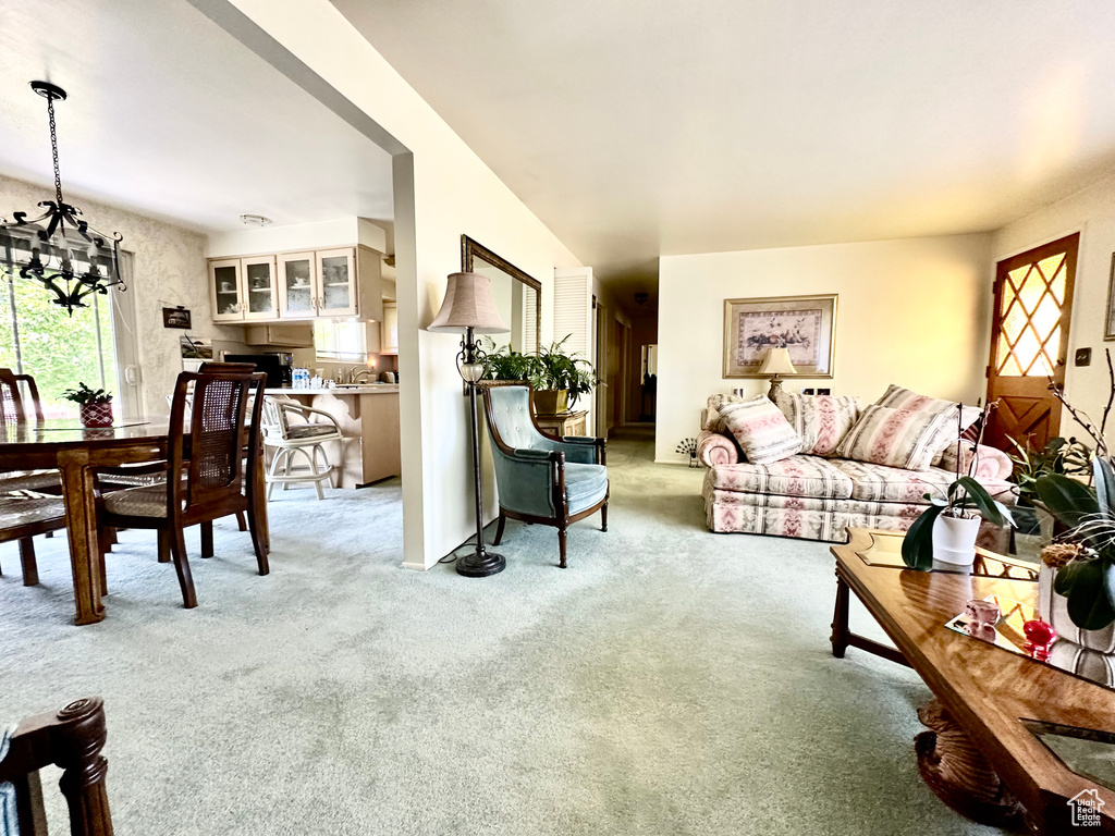 Living room with a chandelier and light colored carpet