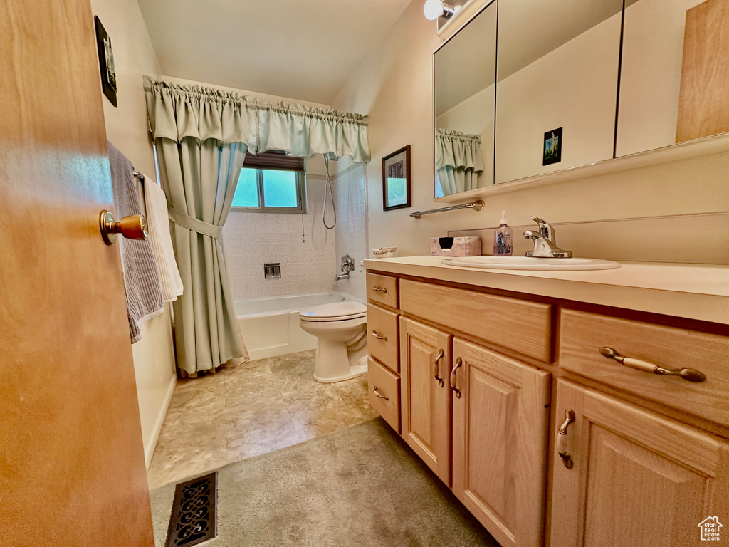 Bathroom featuring vanity and shower / bath combo with shower curtain