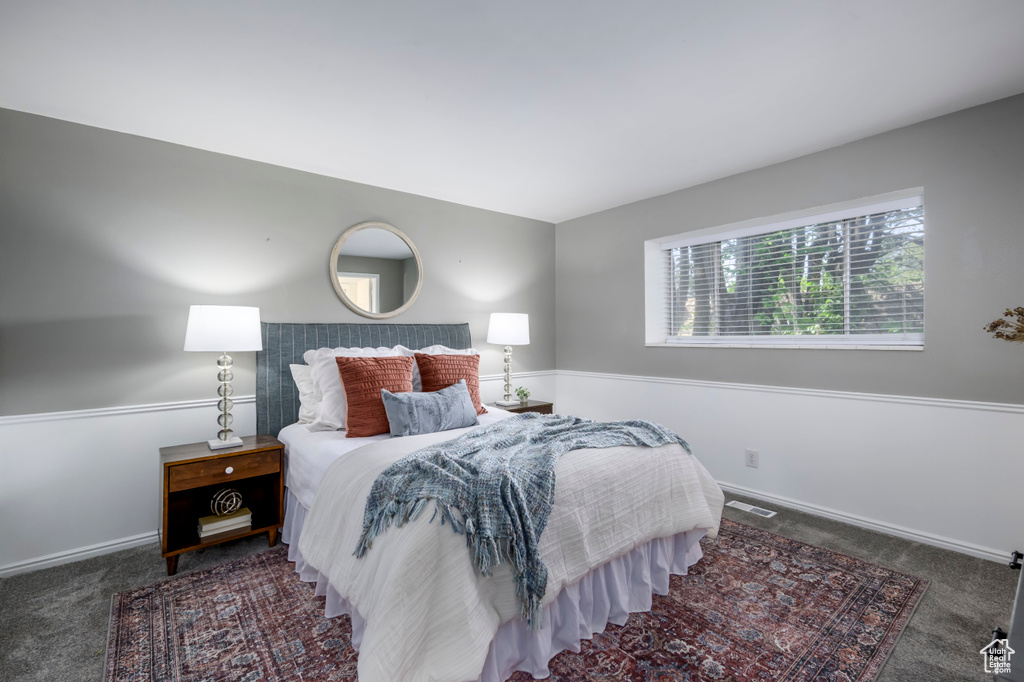 Bedroom featuring carpet floors and baseboards
