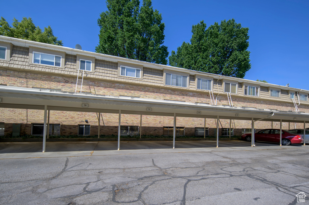 View of front of property with brick siding and covered parking