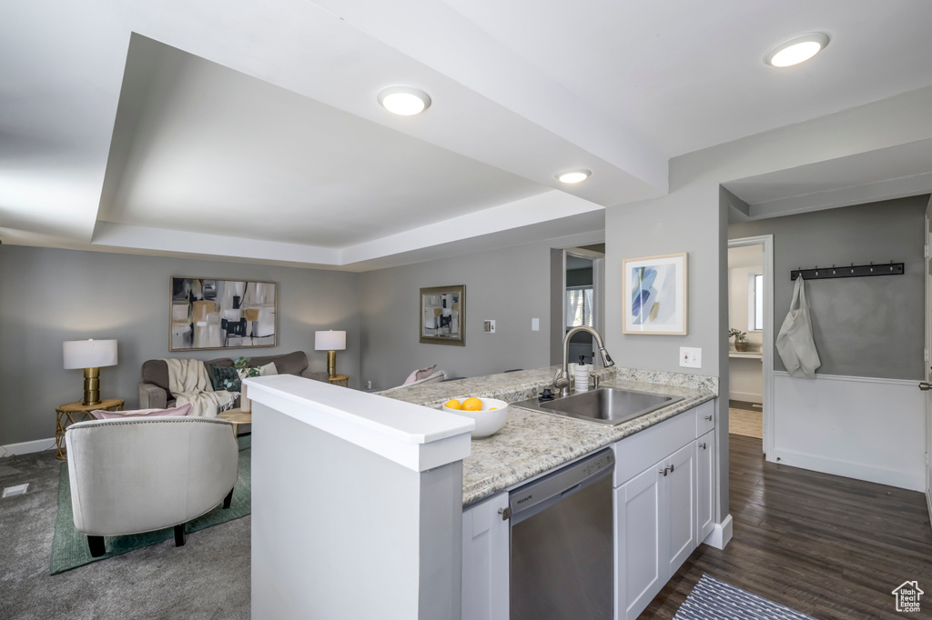 Kitchen featuring dishwasher, open floor plan, white cabinetry, recessed lighting, and a peninsula