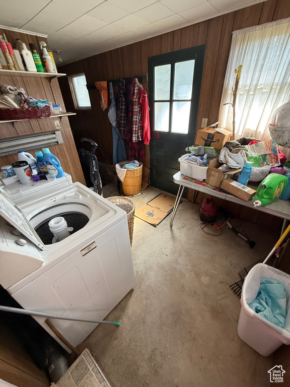 Laundry room featuring wood walls