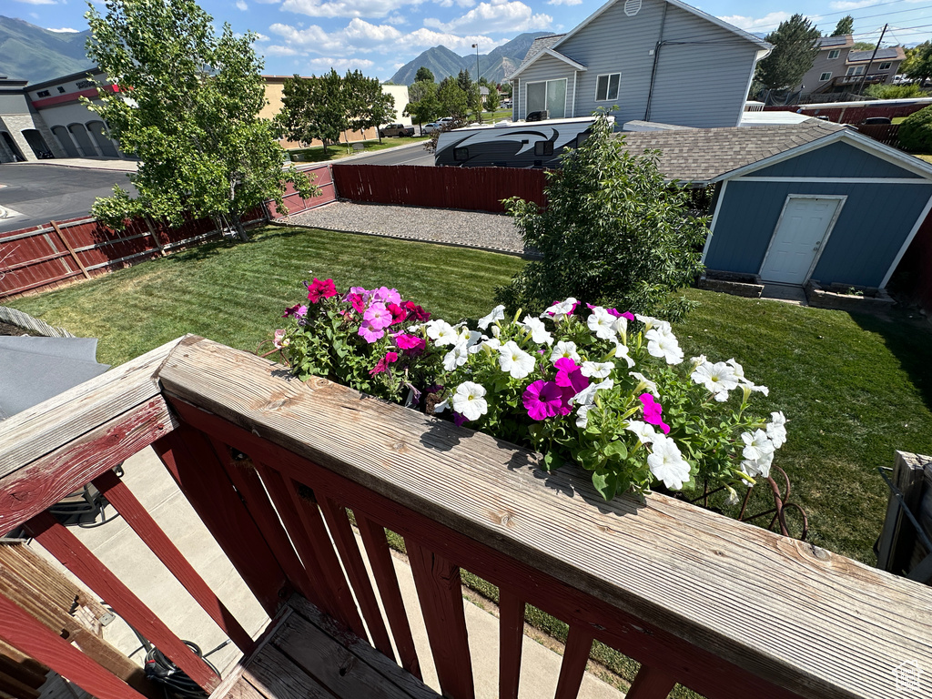 View of yard with a mountain view and a shed