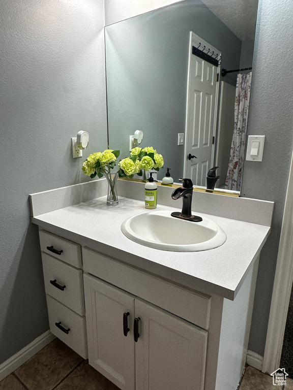 Bathroom featuring vanity and tile patterned floors