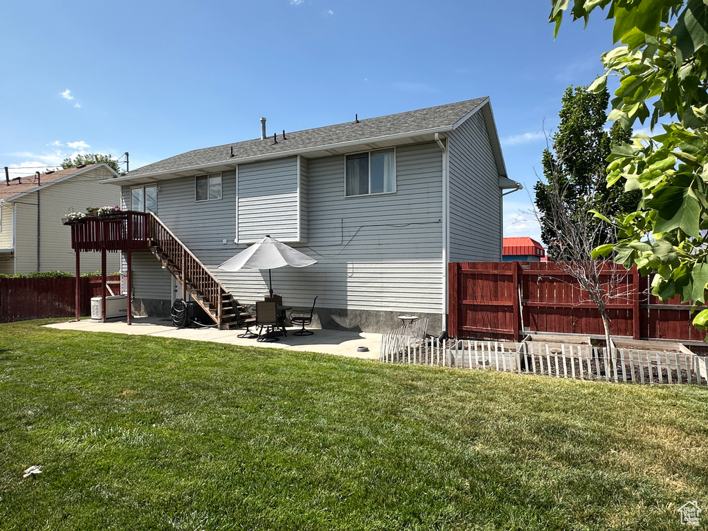 Back of house with a patio area, stairs, and roof with shingles