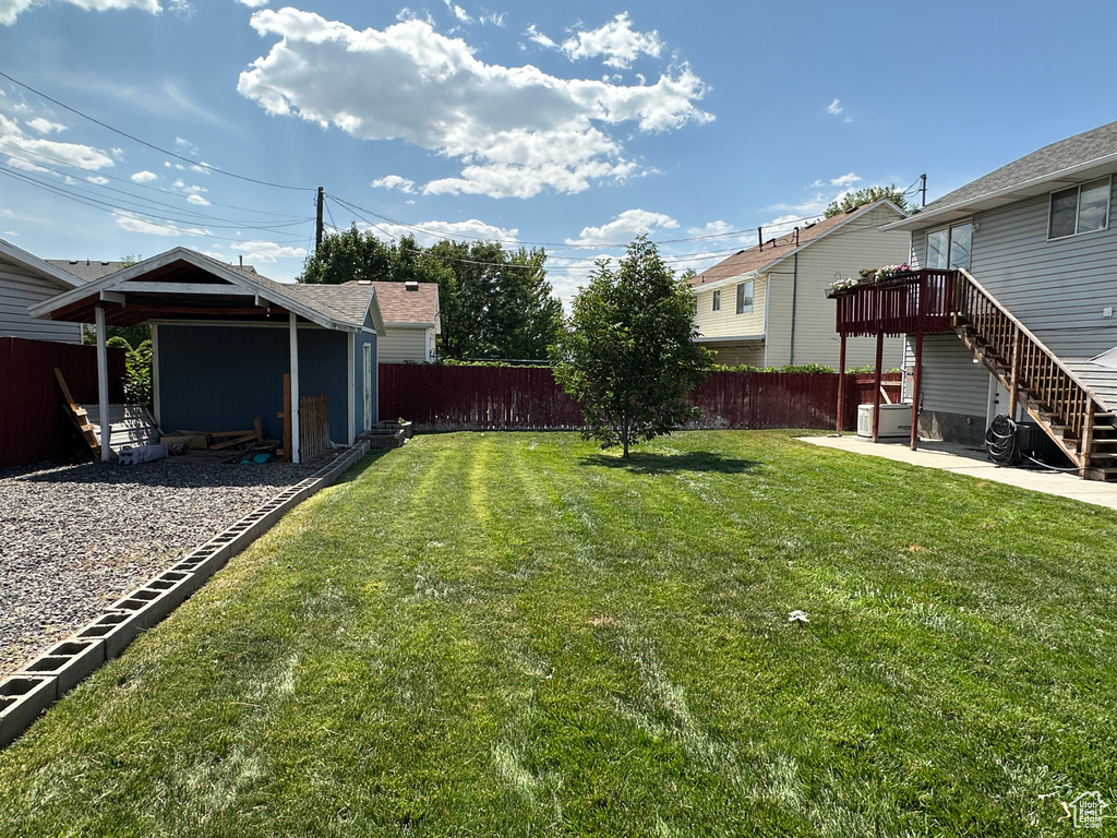 Fenced backyard featuring a patio and stairs