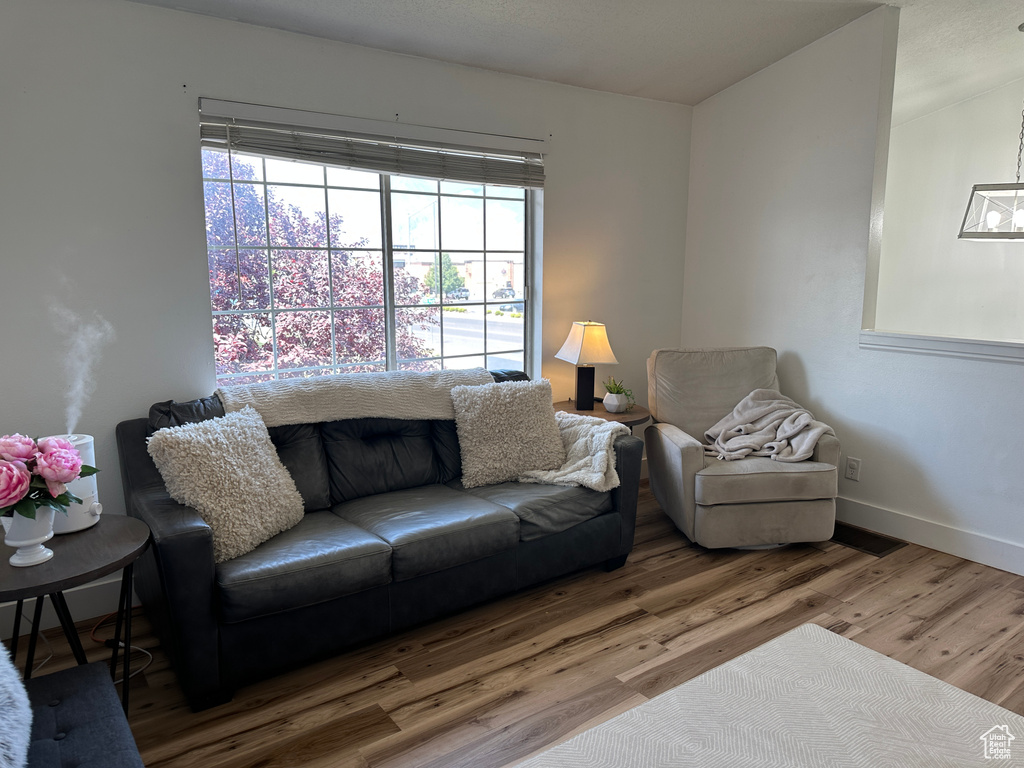 Living area with wood finished floors and baseboards