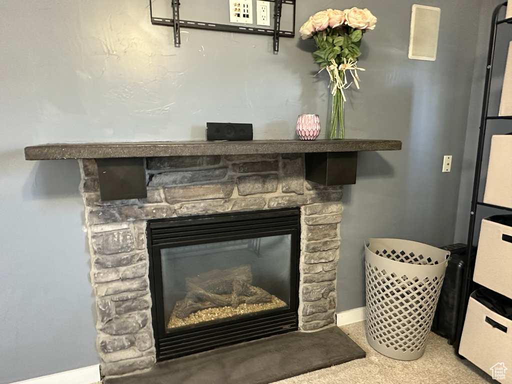 Detailed view of a fireplace and baseboards