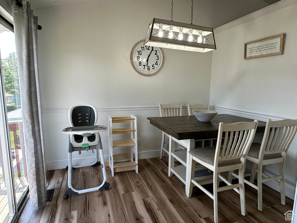 Dining room featuring wood finished floors and ornamental molding