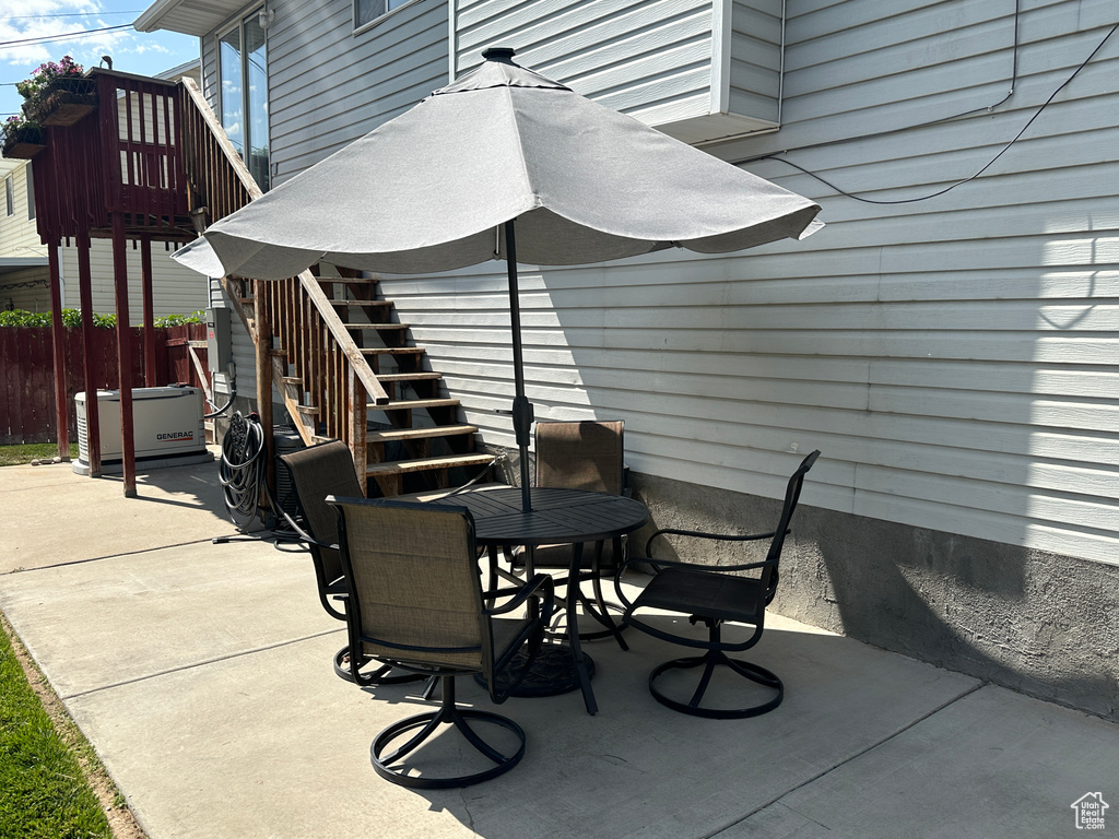 View of patio featuring stairway and outdoor dining space