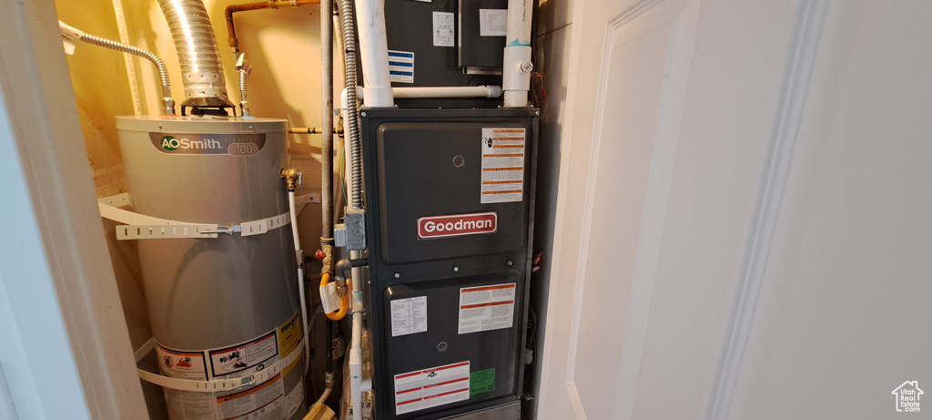 Utility room with strapped water heater and heating unit