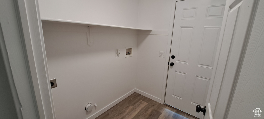 Laundry area with electric dryer hookup, gas dryer hookup, dark wood finished floors, and washer hookup