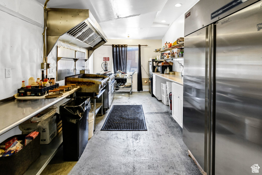 Kitchen with premium fridge, white cabinets, concrete floors, open shelves, and recessed lighting