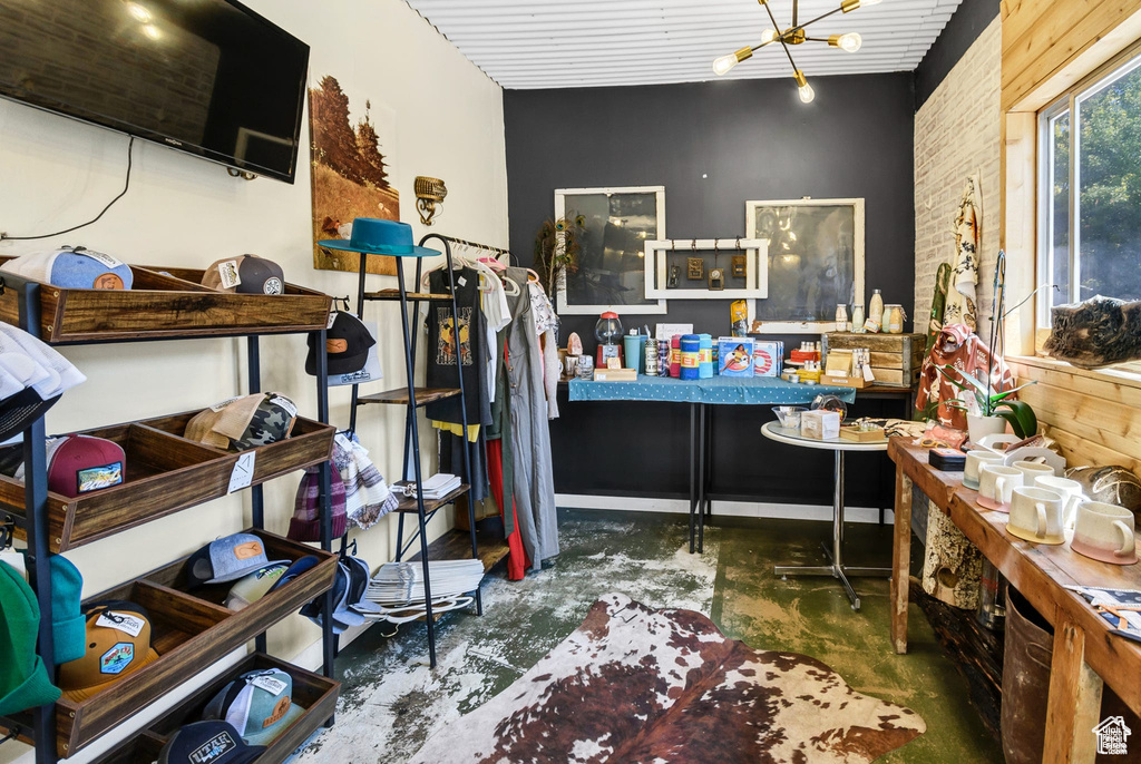 Office with concrete floors and a chandelier