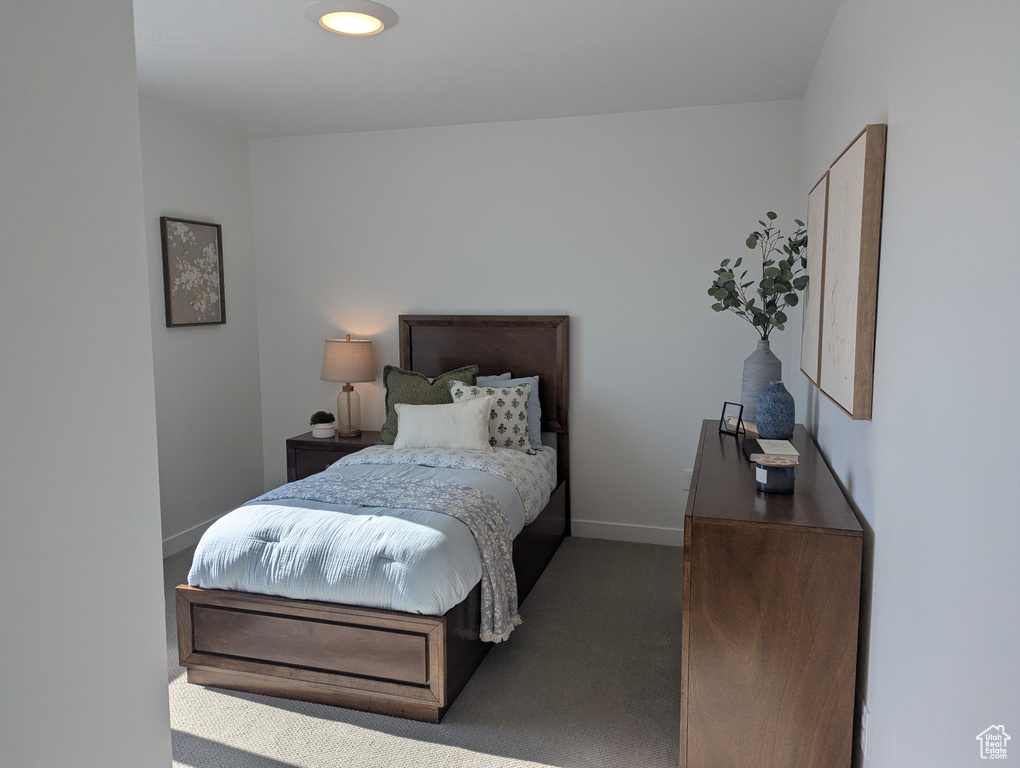 Carpeted bedroom featuring baseboards
