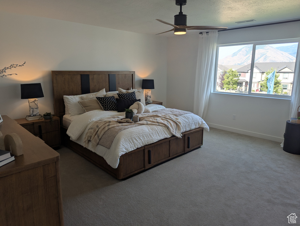 Bedroom with light carpet and ceiling fan