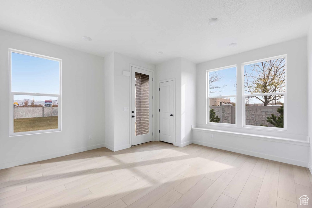 Empty room featuring light wood-style flooring and baseboards