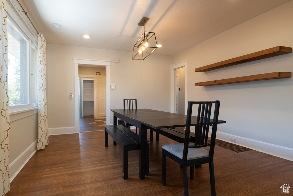 Dining area with dark wood-style flooring and recessed lighting