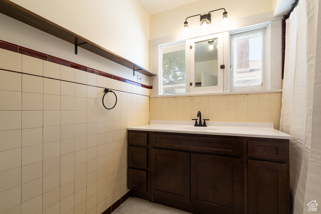 Full bathroom with tile walls and vanity