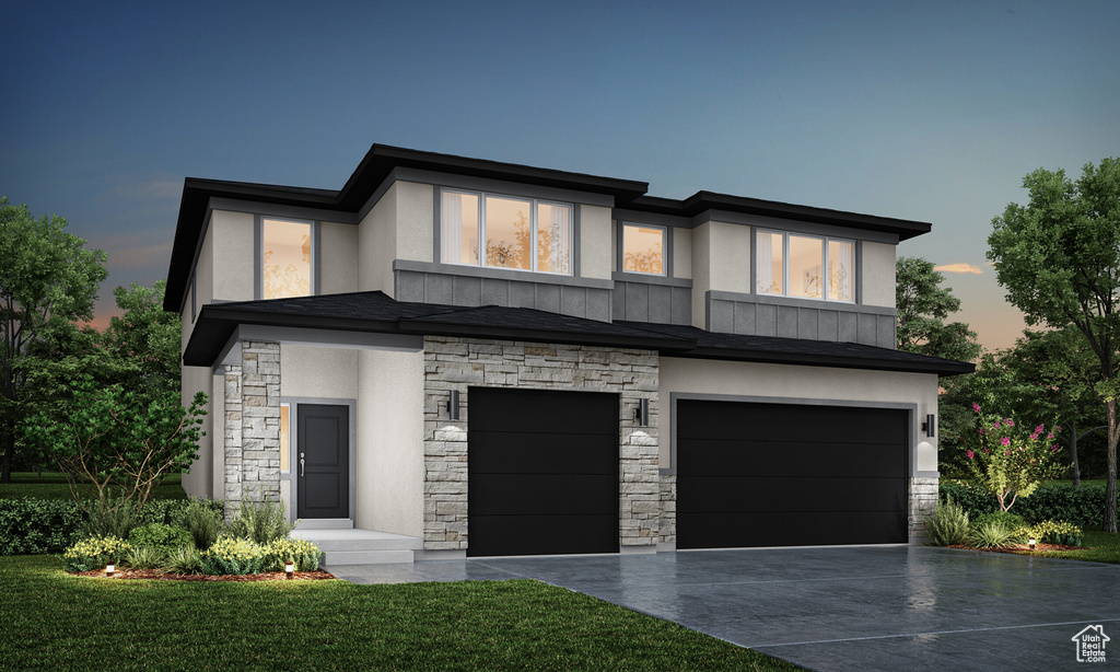 View of front of home with a garage, stone siding, driveway, stucco siding, and a front yard