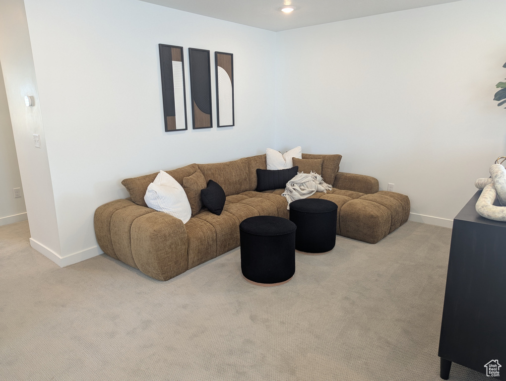 Carpeted living room with baseboards