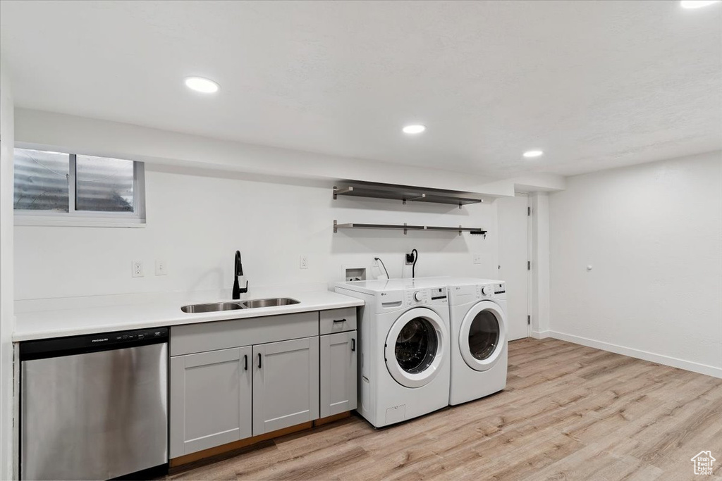 Laundry area with washer and clothes dryer, light wood-type flooring, and recessed lighting