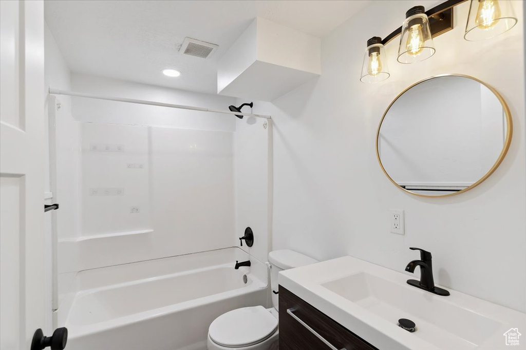 Full bathroom featuring vanity, shower / bath combination, and recessed lighting