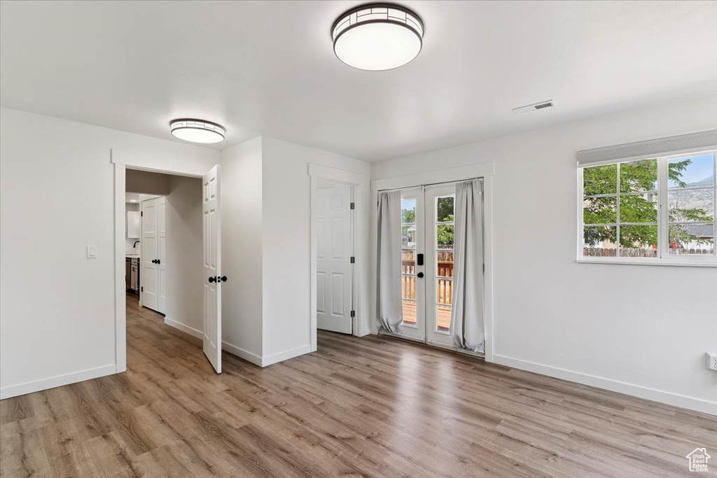 Unfurnished bedroom featuring light wood-type flooring and access to outside