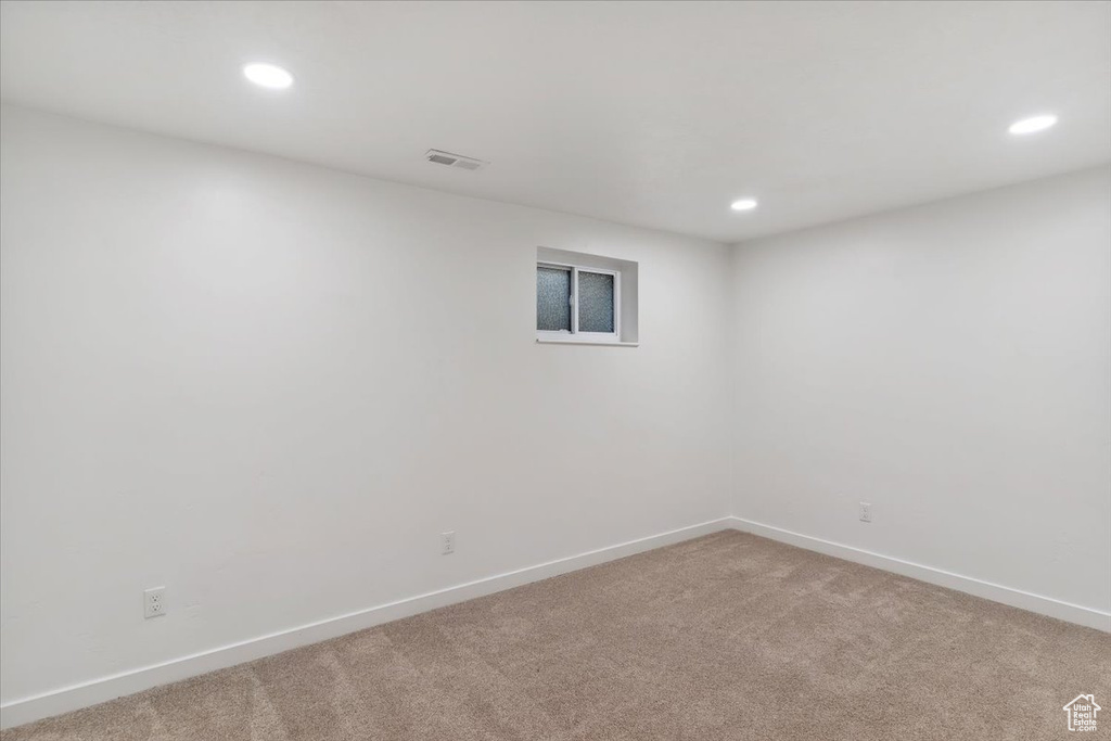 Unfurnished room with recessed lighting and light carpet
