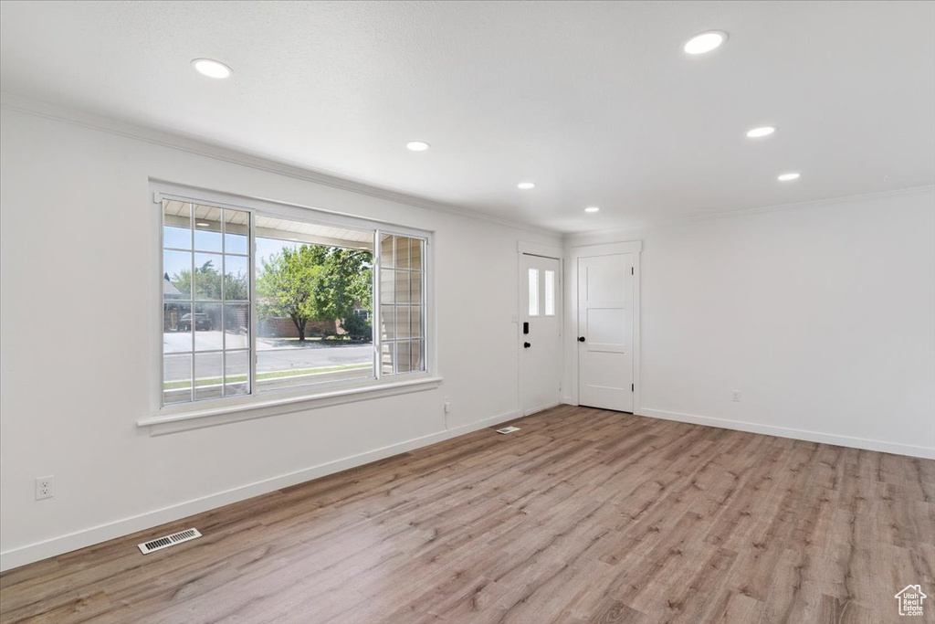 Unfurnished room with crown molding, recessed lighting, and wood finished floors