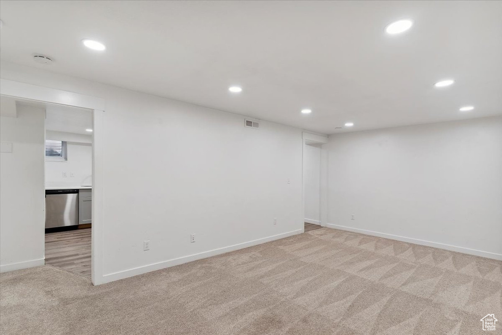 Spare room featuring light colored carpet, recessed lighting, and a smoke detector