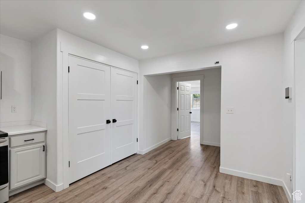 Foyer with light wood-style floors and recessed lighting