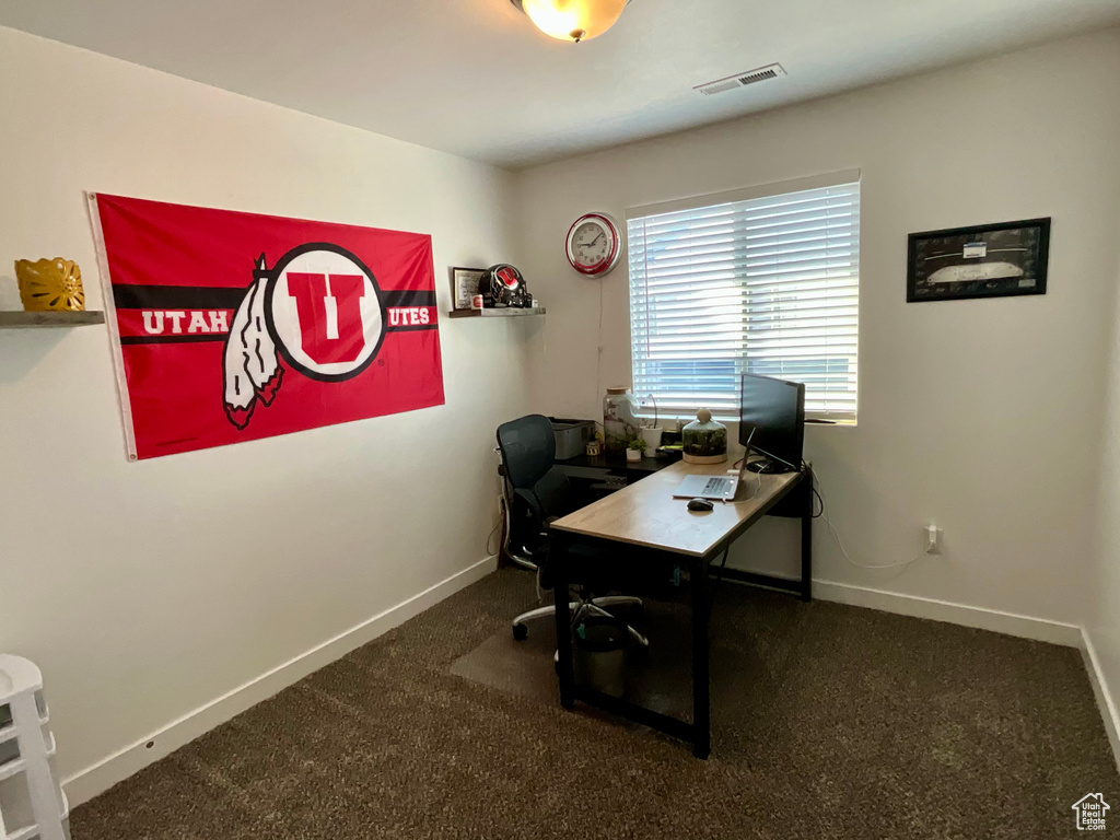 Office area featuring baseboards and carpet