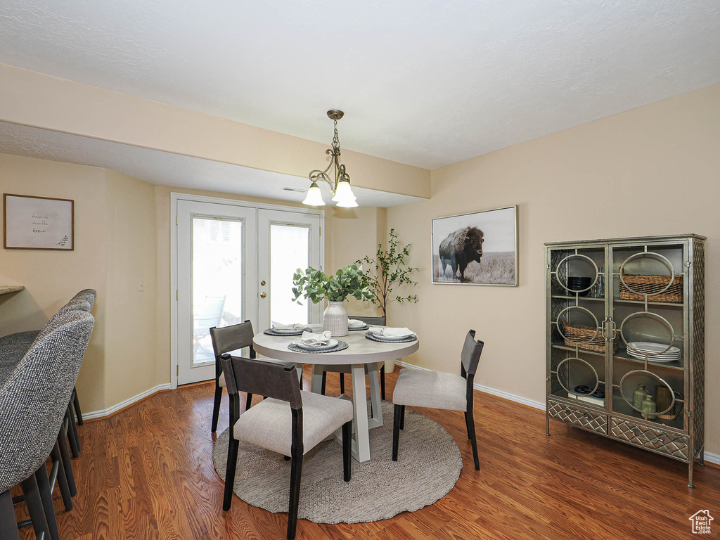 Dining room featuring wood finished floors and a chandelier