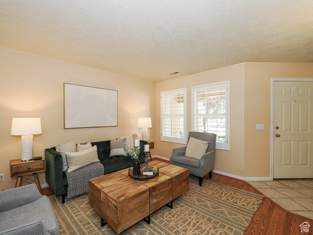 Living room with wood finished floors and a textured ceiling