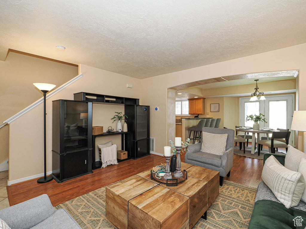 Living room with a textured ceiling and wood finished floors