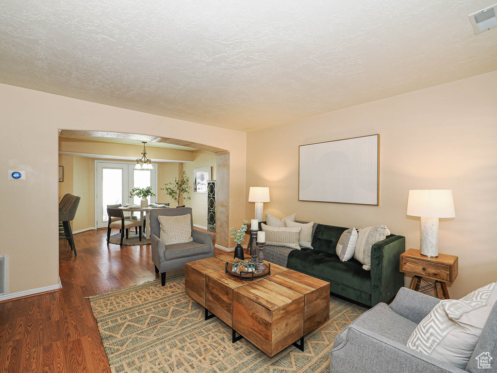 Living room with wood finished floors and a textured ceiling