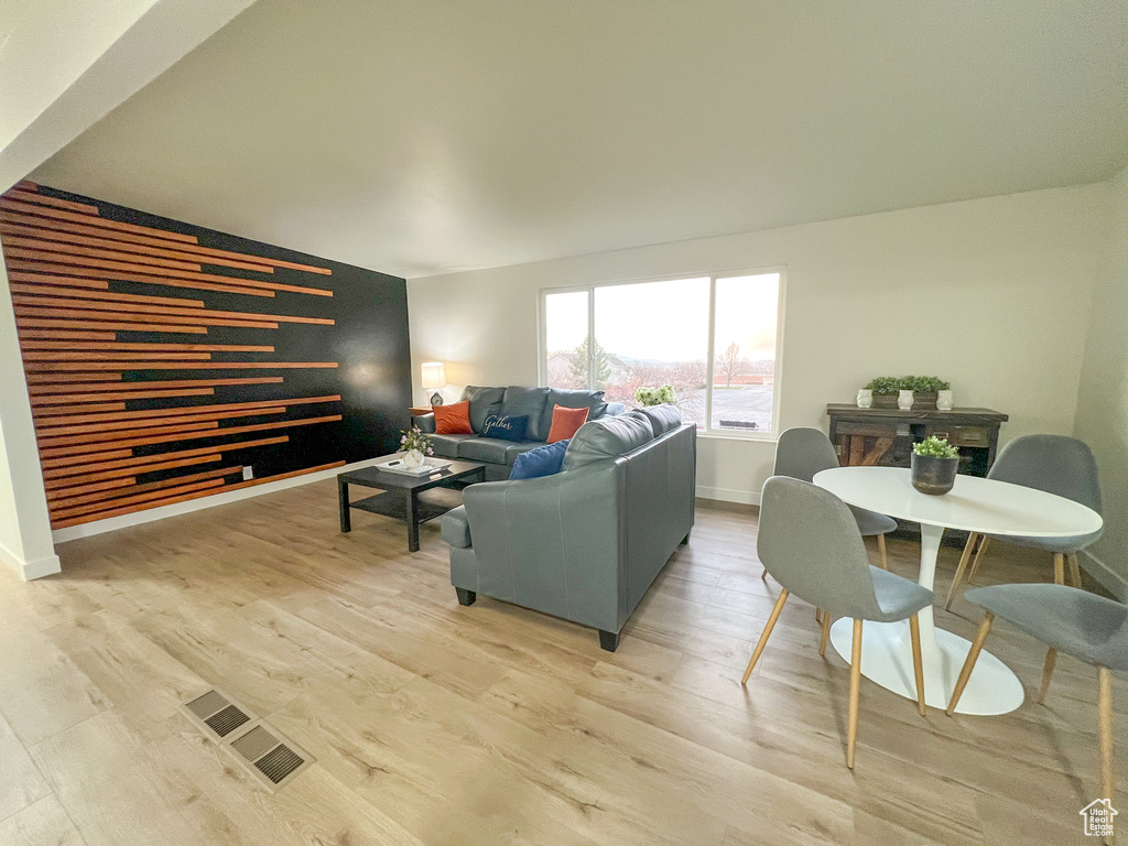 Living room with light wood-style floors and baseboards