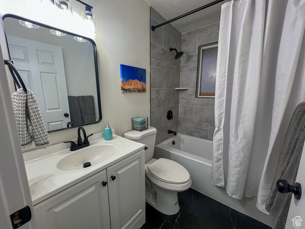 Bathroom featuring vanity and shower / bath combo