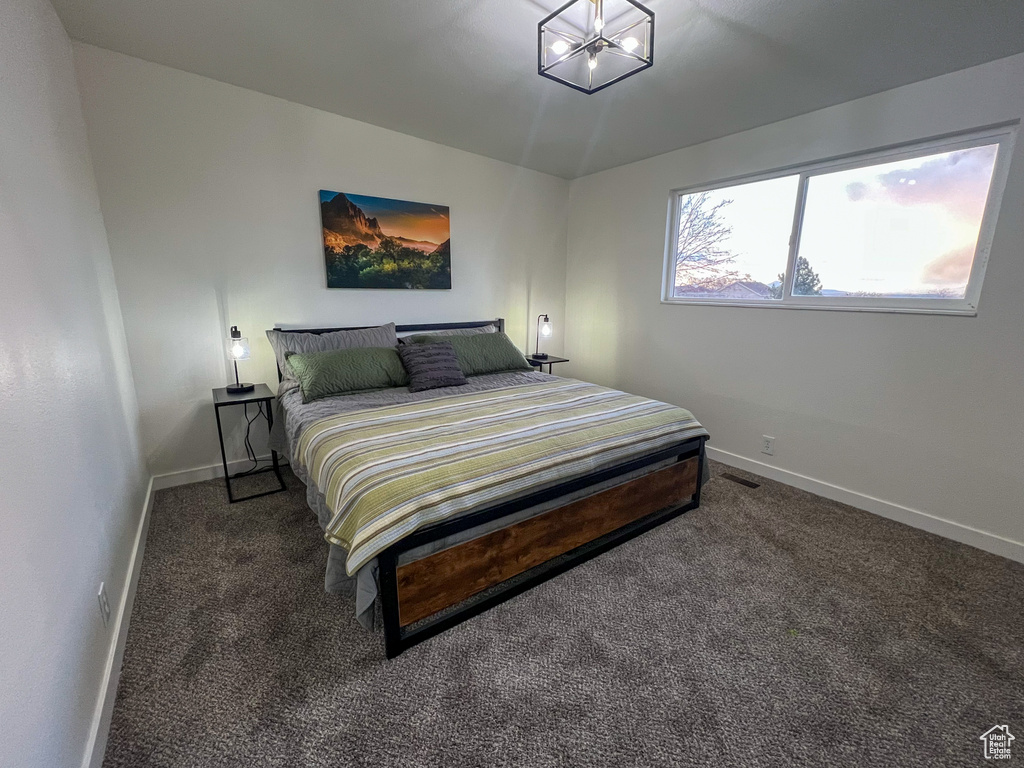 Bedroom featuring baseboards and carpet floors