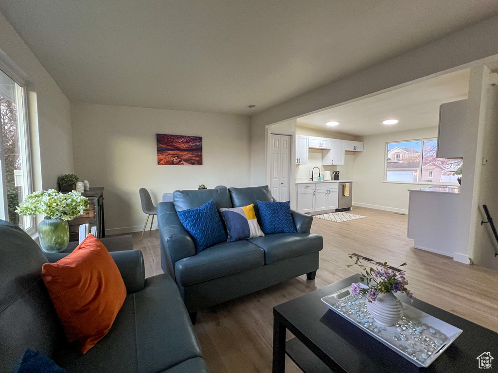 Living room featuring light wood finished floors and recessed lighting