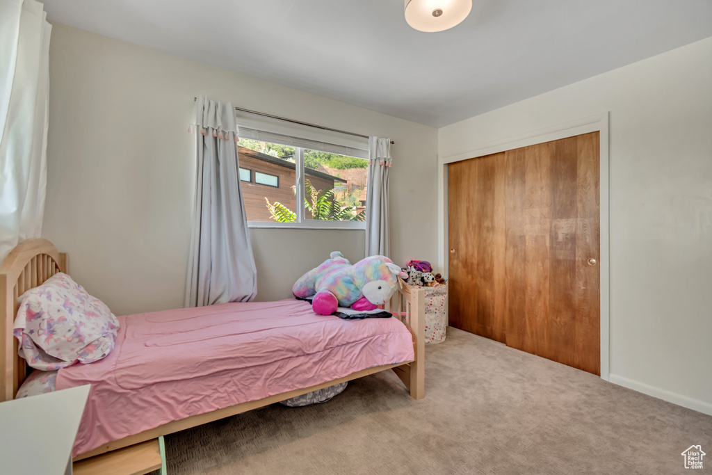 Bedroom with carpet flooring and a closet