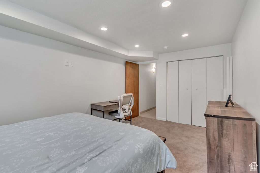 Bedroom with carpet floors, recessed lighting, and a closet