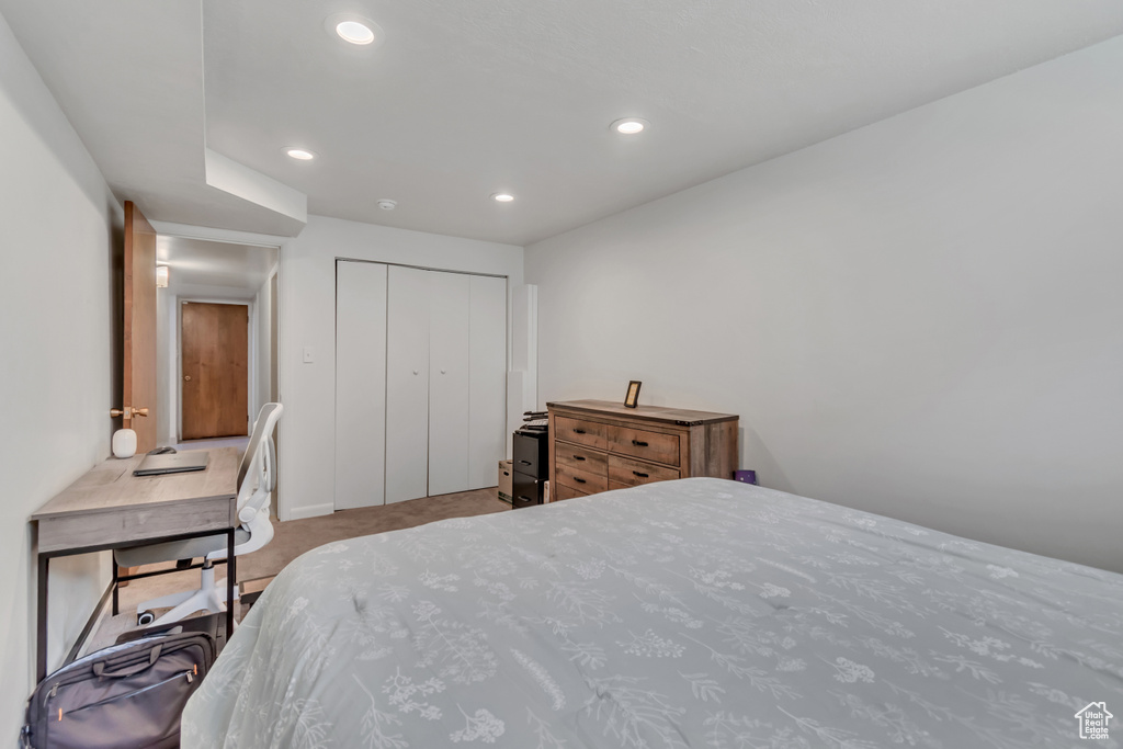 Carpeted bedroom featuring recessed lighting and a closet