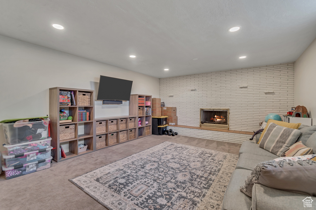 Carpeted living room featuring recessed lighting and a brick fireplace
