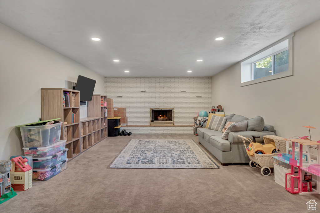 Recreation room featuring recessed lighting, carpet, and a fireplace