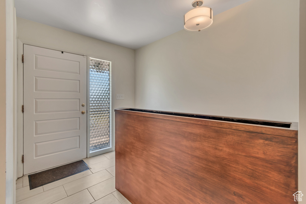Entrance foyer with light tile patterned floors