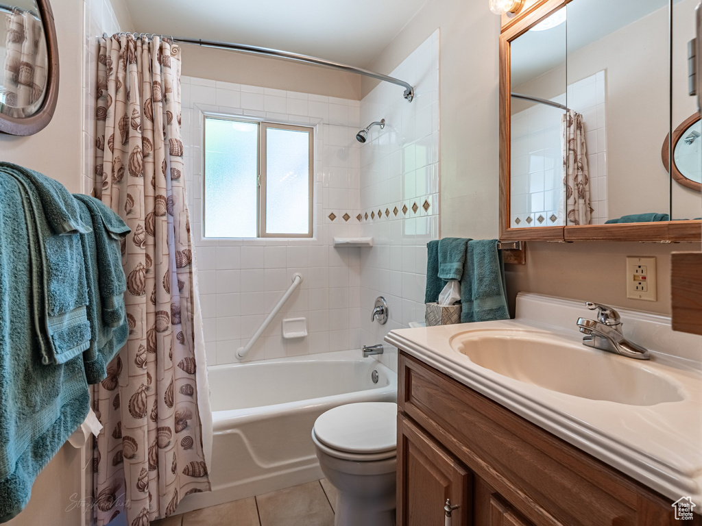 Full bath featuring shower / bath combination with curtain, tile patterned floors, and vanity