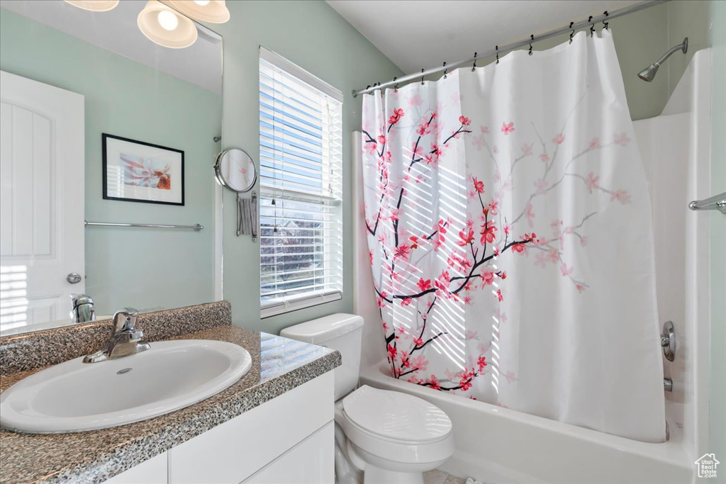 Full bathroom with vanity and shower / tub combo